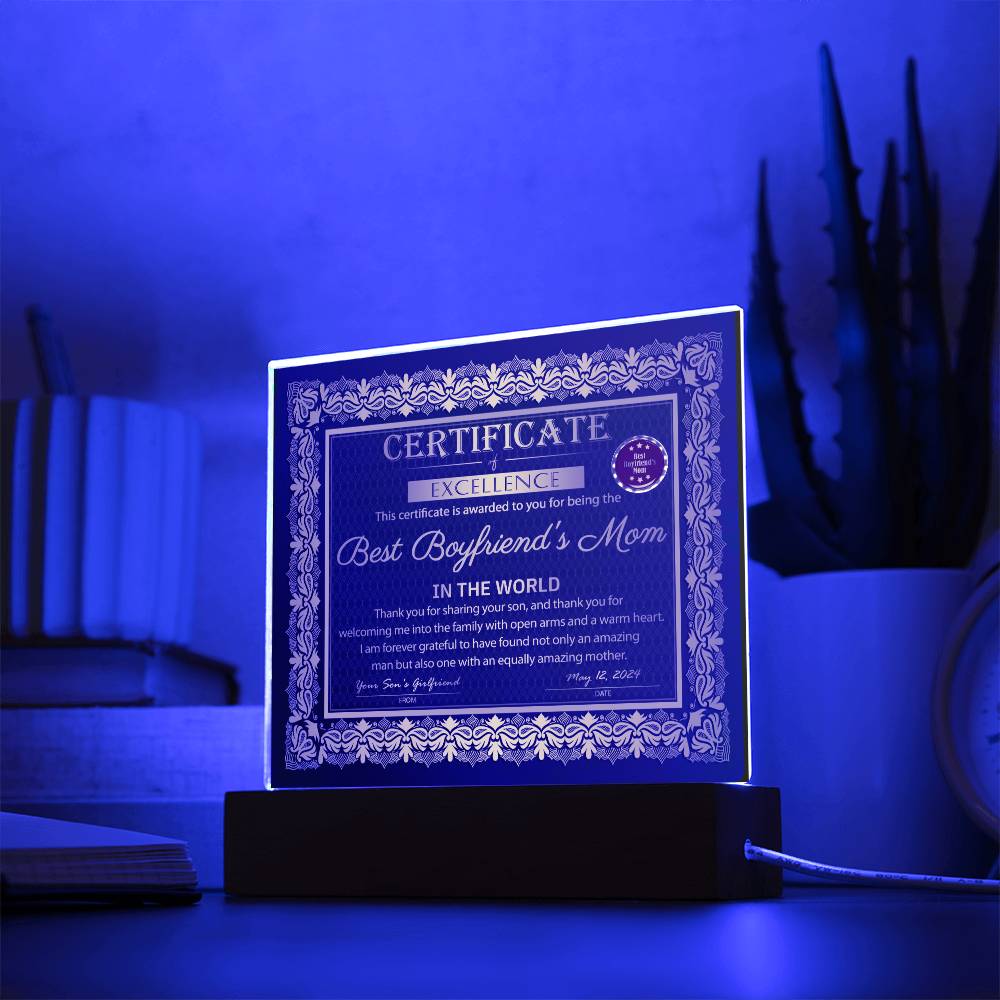 A decorative "To Boyfriend's Mom-Certificate of Excellence - Acrylic Square Plaque" on an LED wooden base, featuring ornate golden borders and a red seal.