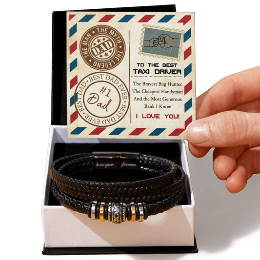 Hand holding a greeting card next to a "To Dad, Generous Bank - Love You Forever Bracelet" with metal accents in an open gift box. The card reads: “To the Best Taxi Driver, #1 Dad.” The sleek bracelet features vegan leather, making it an eco-friendly choice for your loved one.