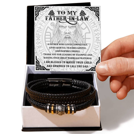 A hand holding a card that reads "To My Father-In-Law," accompanied by a "To Father-in-Law, Leading By Example - Love You Forever Bracelet" in an open box.