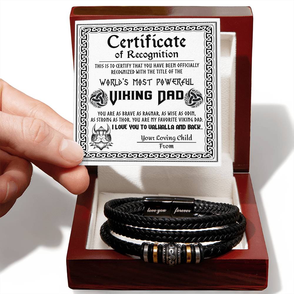 A hand holds a gift box containing a To Dad, The Viking Dad - Love You Forever Bracelet with metal beads, alongside a "world's most powerfully punishing dad" certificate.