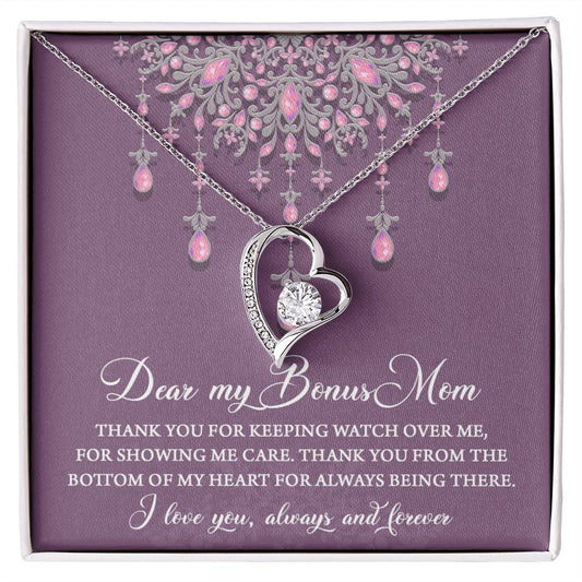 A "To Bonus Mom, Always Being There - Forever Love Necklace" with a heart pendant and pink gemstones displayed in a box with a heartfelt message, perfect as a gift for mom.