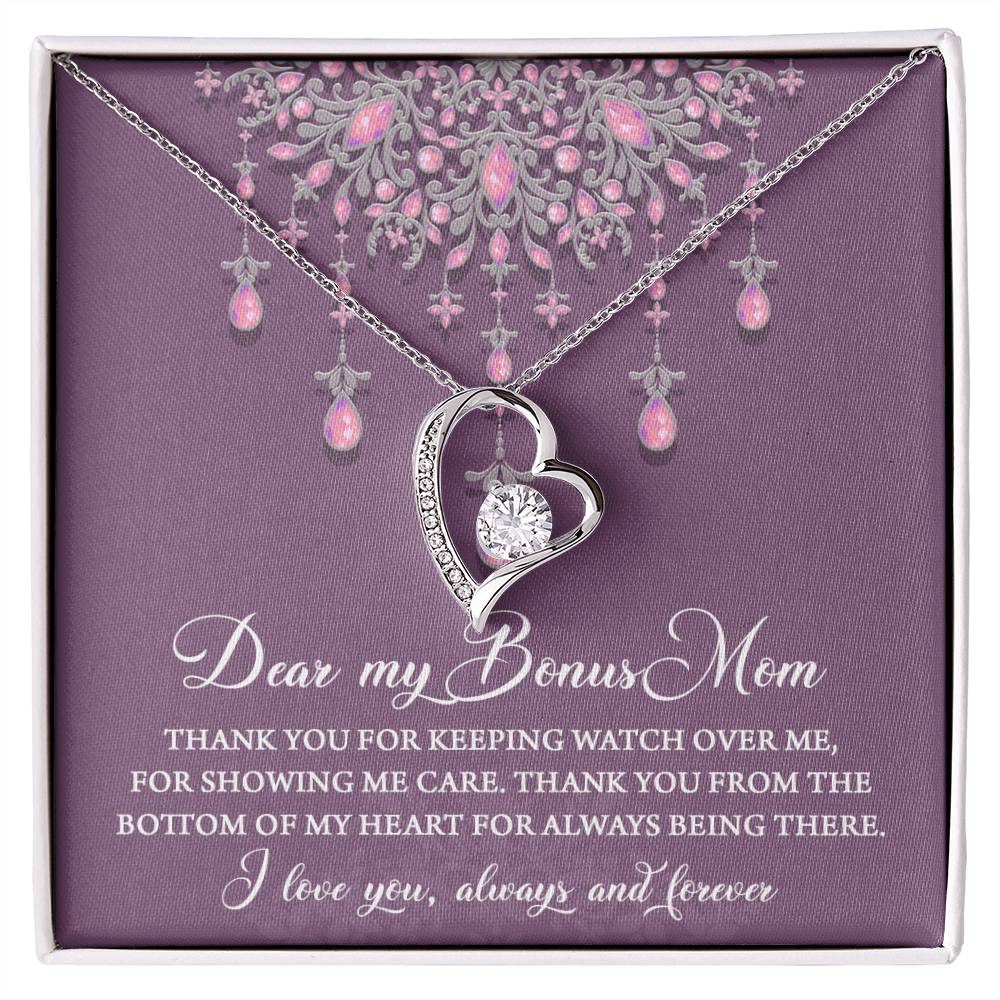 A "To Bonus Mom, Always Being There - Forever Love Necklace" with a heart pendant and pink gemstones displayed in a box with a heartfelt message, perfect as a gift for mom.