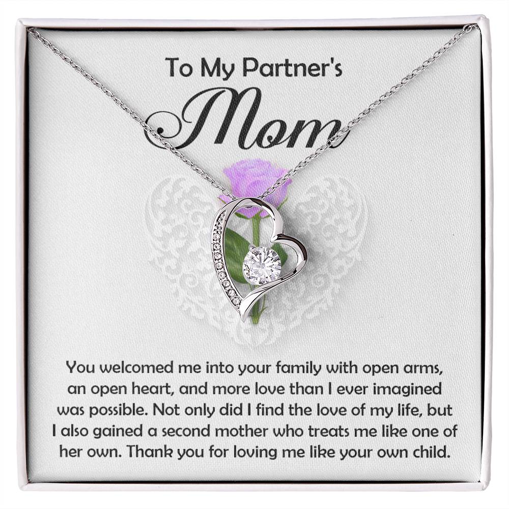 The Partner's Mom-A Second Mother - Forever Love Necklace, a silver heart-shaped pendant with a sparkling CZ crystal, is displayed in a box that says "To My Partner's Mom" and includes a heartfelt message of gratitude and love.