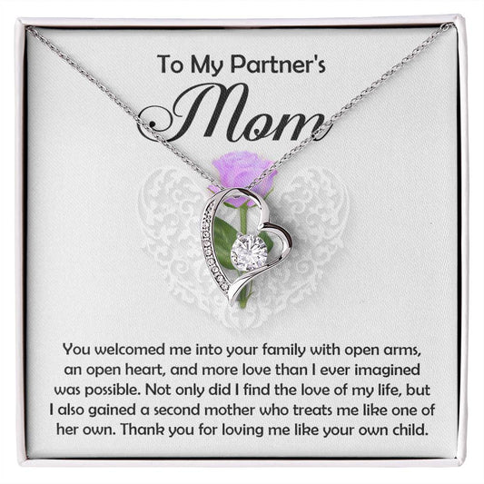 The Partner's Mom-A Second Mother - Forever Love Necklace, a silver heart-shaped pendant with a sparkling CZ crystal, is displayed in a box that says "To My Partner's Mom" and includes a heartfelt message of gratitude and love.