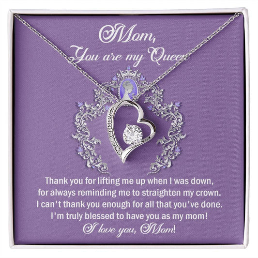 A heart-shaped To Mom, Belongs To Me - Forever Love Necklace with a crown design, inscribed with a heartfelt message to mom, presented in a purple box.