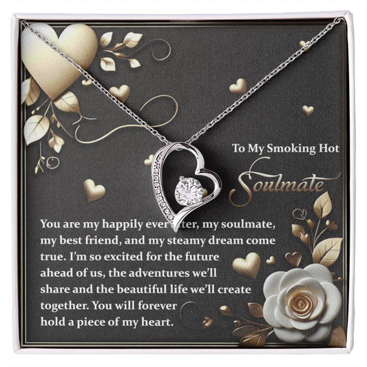 The Soulmate-The Future - Forever Love Necklace features a heart-shaped pendant with sparkling cubic zirconia. It comes in a floral-decorated box with heartfelt messages, showcasing a charming gold finish and heart graphics.