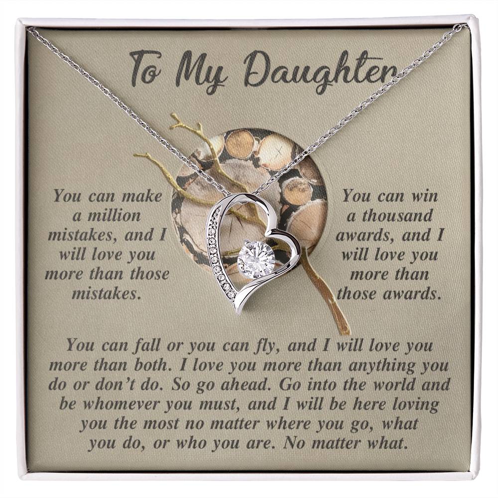 The Daughter-A Thousand Awards - Forever Love Necklace showcases a heart-shaped design adorned with a brilliant CZ crystal set in a gold finish, accompanied by a card containing heartfelt messages for your daughter.