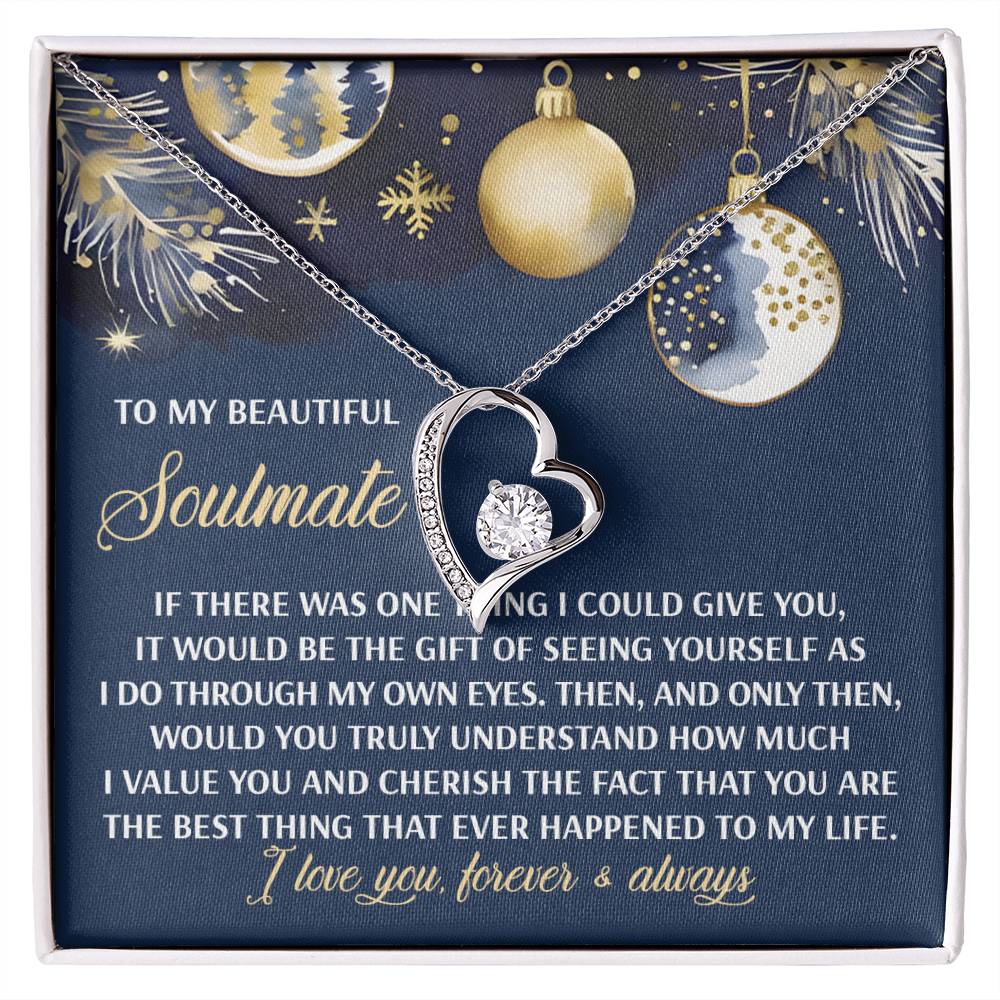 The Soulmate-One Thing - Forever Love Necklace, featuring a heart-shaped design with a CZ crystal, gracefully rests on a card embellished with gold and silver ornament designs. This card conveys a heartfelt message of appreciation for a soulmate, perfectly accentuated by the necklace's striking gold finish.