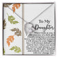 The Daughter-Biggest Fan - Forever Love Necklace, adorned with a heart-shaped design and CZ crystal, is gracefully showcased on a greeting card decorated with autumn leaves, conveying a message of lasting love.