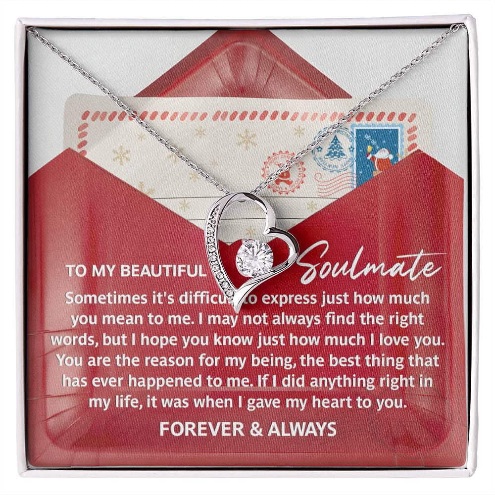 The Soulmate-Right Words - Forever Love Necklace showcases a heart-shaped pendant with an exquisite gold finish, elegantly presented in a box featuring a heartfelt message and a red envelope design, embellished with sparkling cubic zirconia.