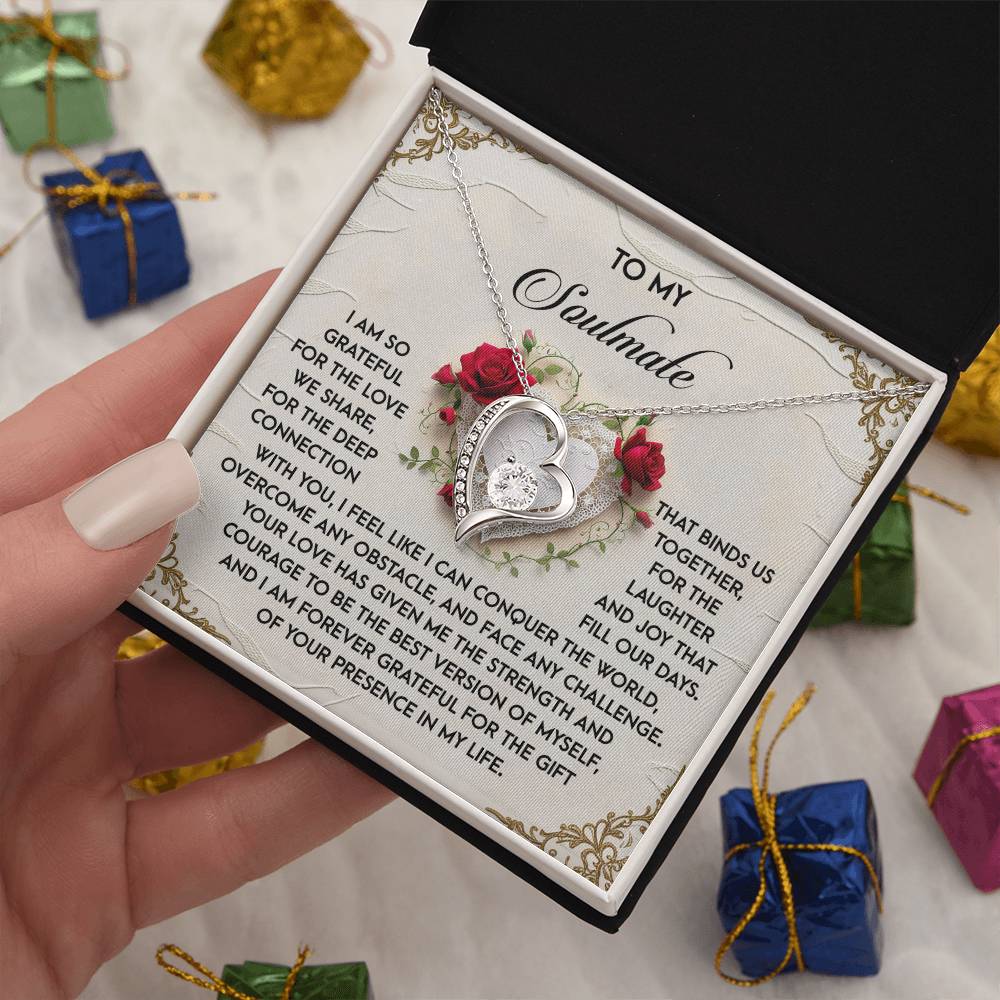 The Soulmate-Our Days - Forever Love Necklace, featuring shimmering CZ crystals and a white gold finish, comes in a gift box with a heartfelt note for your soulmate, amidst small wrapped presents.