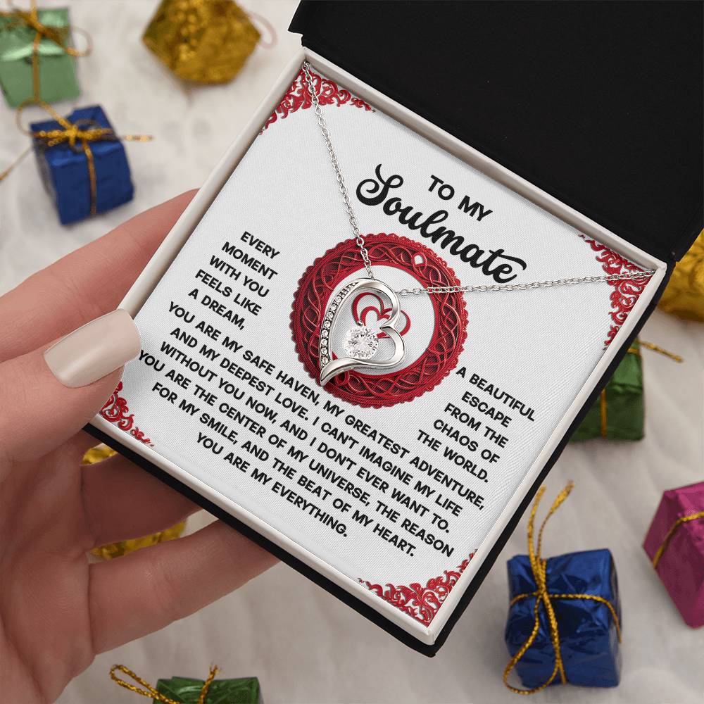 A person holds a "Soulmate-Like A Dream - Forever Love Necklace" in a gift box labeled "To My Soulmate," featuring an elegant white gold finish and sparkling cubic zirconia stone, surrounded by decorative small wrapped presents.
