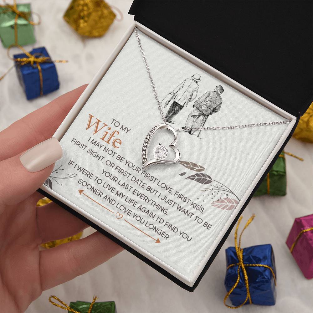 A hand holding an open jewelry gift box with a ShineOn Fulfillment Forever Love Necklace and a pendant, alongside a sentimental printed message for a wife.