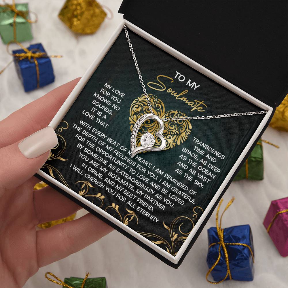 The "Soulmate-The Sky - Forever Love Necklace," with a gold finish and CZ crystal accents, is elegantly placed in a gift box with a romantic letter to your soulmate, surrounded by colorful small gift boxes.