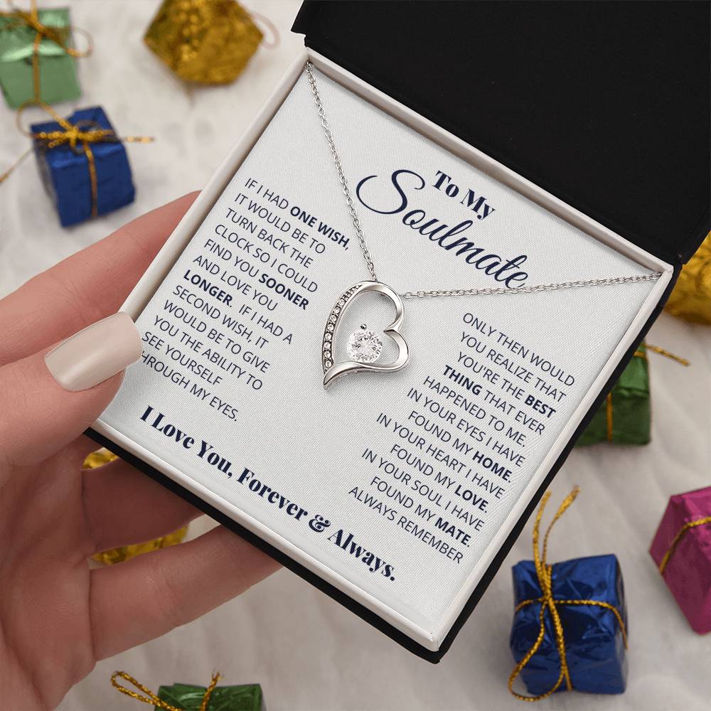 A hand holds open a gift box containing a heart-shaped To My Soulmate, I Love You, Forever & Always - Forever Love Necklace with a gold finish and cubic zirconia, carrying an affectionate message for a soulmate, surrounded by small gift boxes. Brand Name: ShineOn Fulfillment