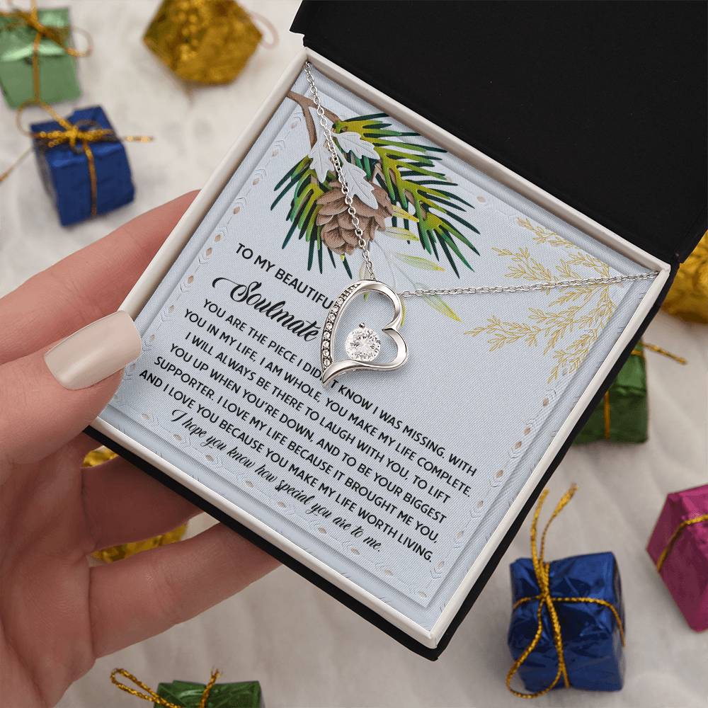 The gift box presents the exquisite Soulmate-Biggest Supporter - Forever Love Necklace, featuring a heart-shaped pendant adorned with sparkling CZ crystals and finished in elegant gold. It includes an emotional message card and is surrounded by small wrapped presents.