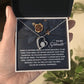 A person holds a jewelry box containing the Soulmate-Eternal Happiness - Forever Love Necklace, with a heart-shaped pendant in white gold finish. Inside is a card with a romantic message for their soulmate, shimmering elegantly with CZ crystal accents.