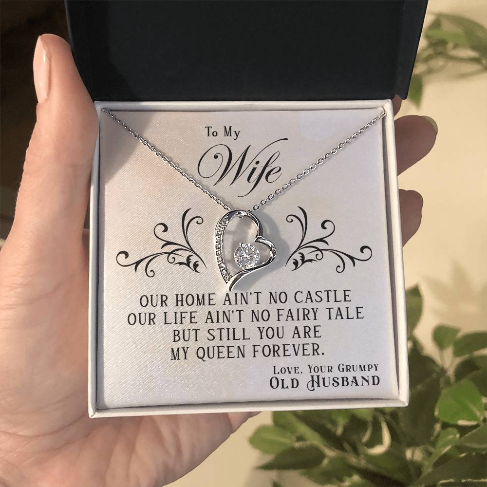 A gold finish heart-shaped pendant necklace inside a gift box with a message to a wife from her husband, titled "To My Wife, You Are My Queen Forever - Forever Love Necklace" by ShineOn Fulfillment.