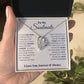 A hand holding an open jewelry box with a ShineOn Fulfillment Forever Love Necklace featuring a heart-shaped pendant and a sentimental message for a soulmate.