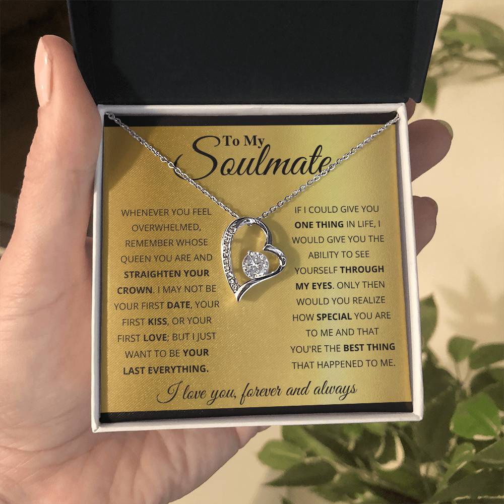 A hand holding an open jewelry box containing a heart-shaped pendant with a gold finish, with the ShineOn Fulfillment To My Soulmate, You_re The BEst Thing That Happened To Me - Forever Love Necklace inscribed inside the lid.