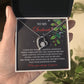 A hand holds an open gift box revealing the Soulmate-You Still Do - Forever Love Necklace. The card displays a romantic message for a soulmate, making it the ideal personalized gift. Decorative holly adorns the card background.