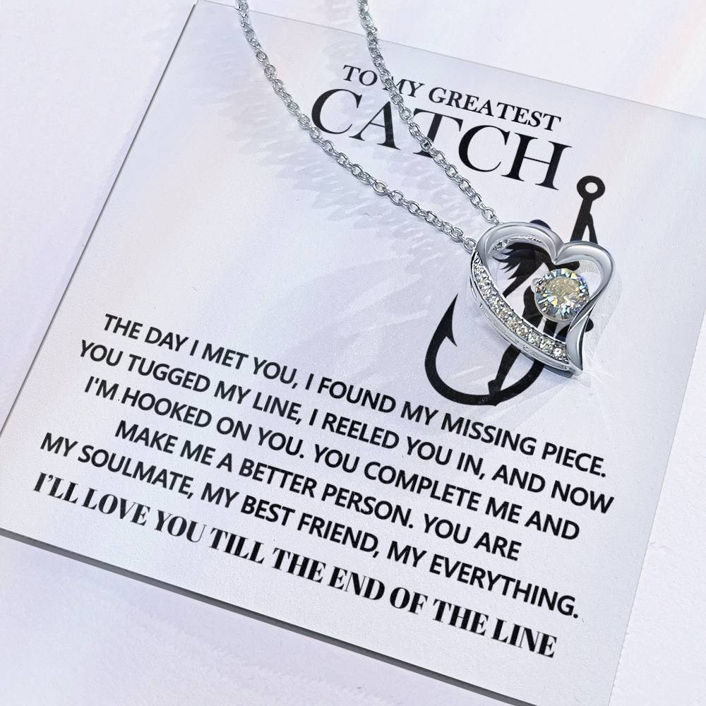 The Soulmate-Hooked On You - Forever Love Necklace showcases a heart-shaped pendant with a sparkling cubic zirconia stone and is presented on a card featuring a romantic fishing-themed message.