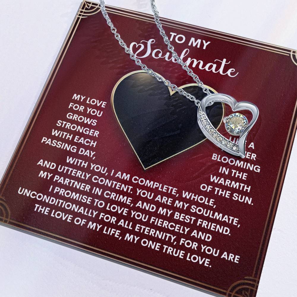 The Soulmate-One True Love - Forever Love Necklace features a heart-shaped pendant with a sparkling cubic zirconia, elegantly displayed on a love-themed card. Available in white gold or yellow gold finish, it’s the ideal gift for your special someone.