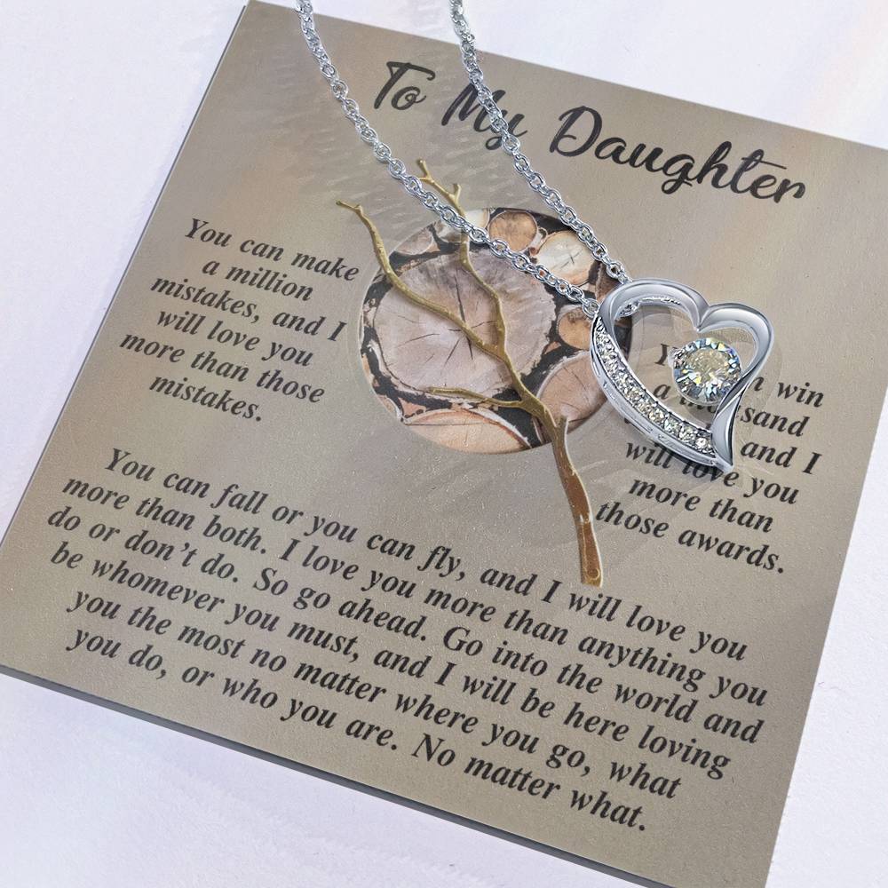 Discover the Daughter-A Thousand Awards - Forever Love Necklace, a heart-shaped piece embellished with radiant cubic zirconia. It comes elegantly displayed on a card featuring an inspirational message for your daughter. With its exquisite gold finish, this necklace embodies eternal love and is crafted to be treasured for a lifetime.