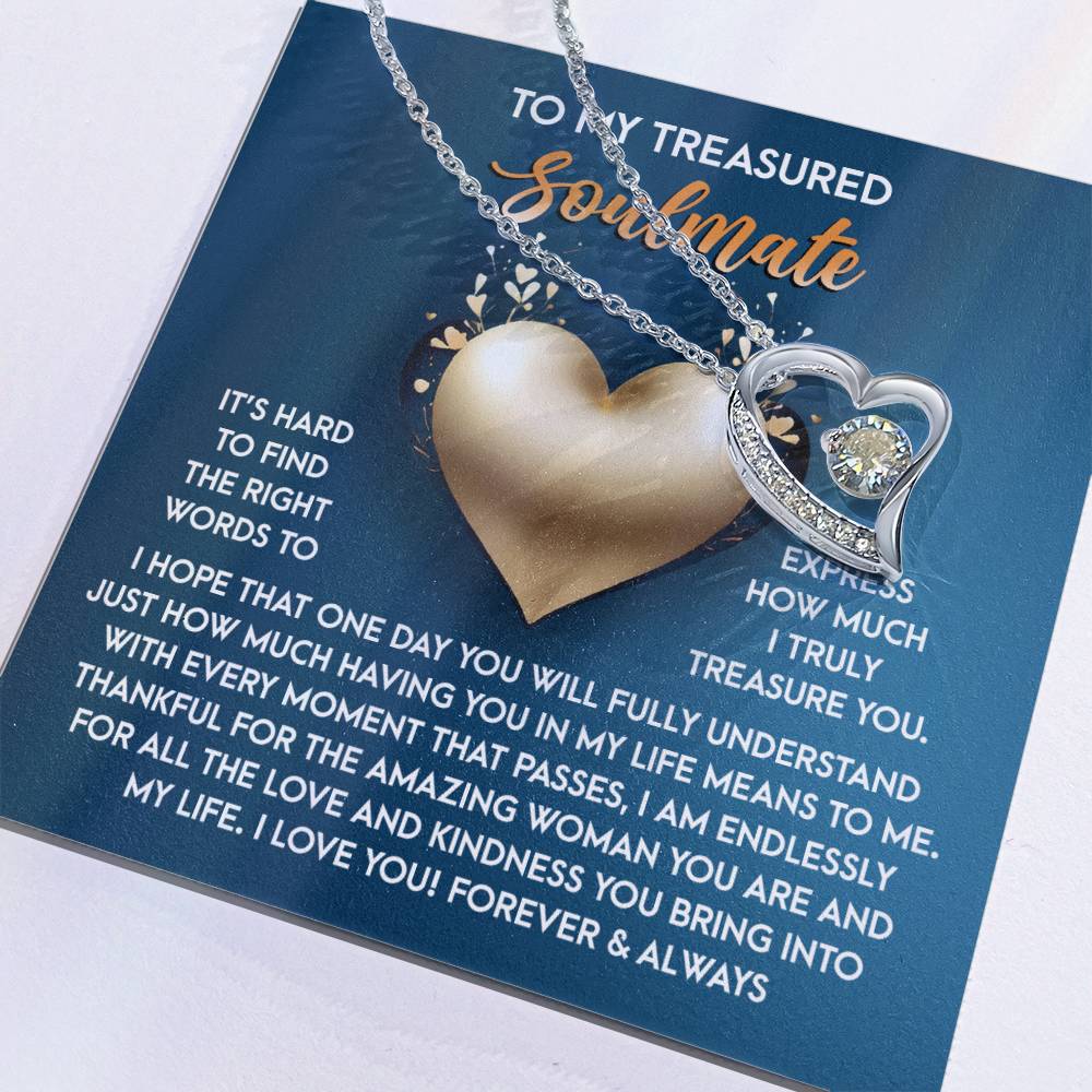 The Soulmate-In My Life - Forever Love Necklace is a heart-shaped pendant with a dazzling CZ crystal on a card. It expresses love and appreciation to a soulmate, set against a blue background with a gold heart design symbolizing eternal devotion.