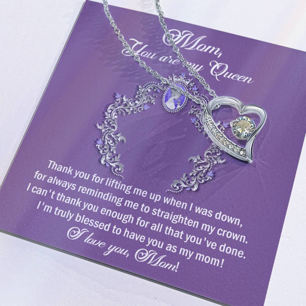 A silver heart-shaped "To Mom, Belongs To Me - Forever Love Necklace" rests on a purple card with the text: "Thank you for lifting me up when I was down. I can't thank you enough for all that you've done! I'm truly blessed to have you as my mom! I love you, Mom!