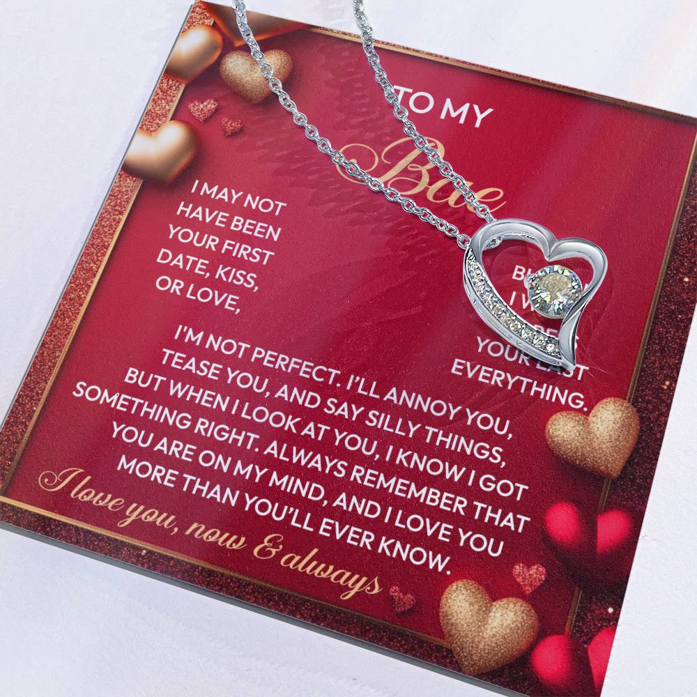 The Soulmate-On My Mind - Forever Love Necklace showcases a heart-shaped pendant with a sparkling CZ crystal on a card with affectionate text and heart patterns, complete with a luxurious white gold finish.