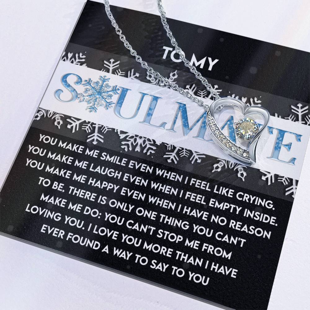 The Soulmate-Loving You - Forever Love Necklace, a beautiful silver heart pendant with a gold finish, is elegantly displayed on a card inscribed with "To My Soulmate" and embellished with a snowflake design. This necklace is adorned with sparkling cubic zirconia and conveys a heartfelt message of love and gratitude.