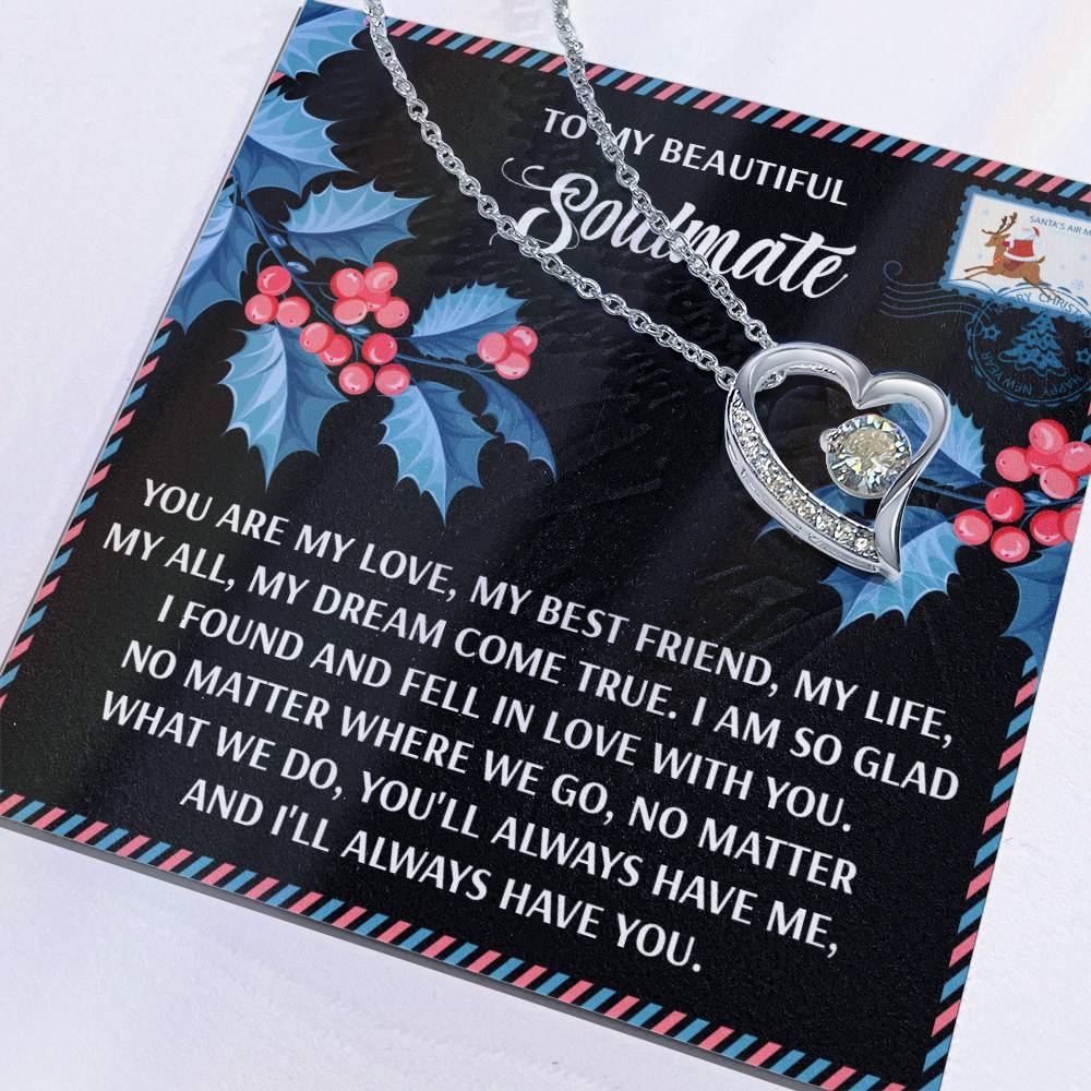 The Soulmate-Fell In Love - Forever Love Necklace features a personalized silver heart-shaped pendant with a stone, atop a holly-decorated card reading: "To my beautiful soulmate, you are my love..." This gift symbolizes your eternal bond and forever love.