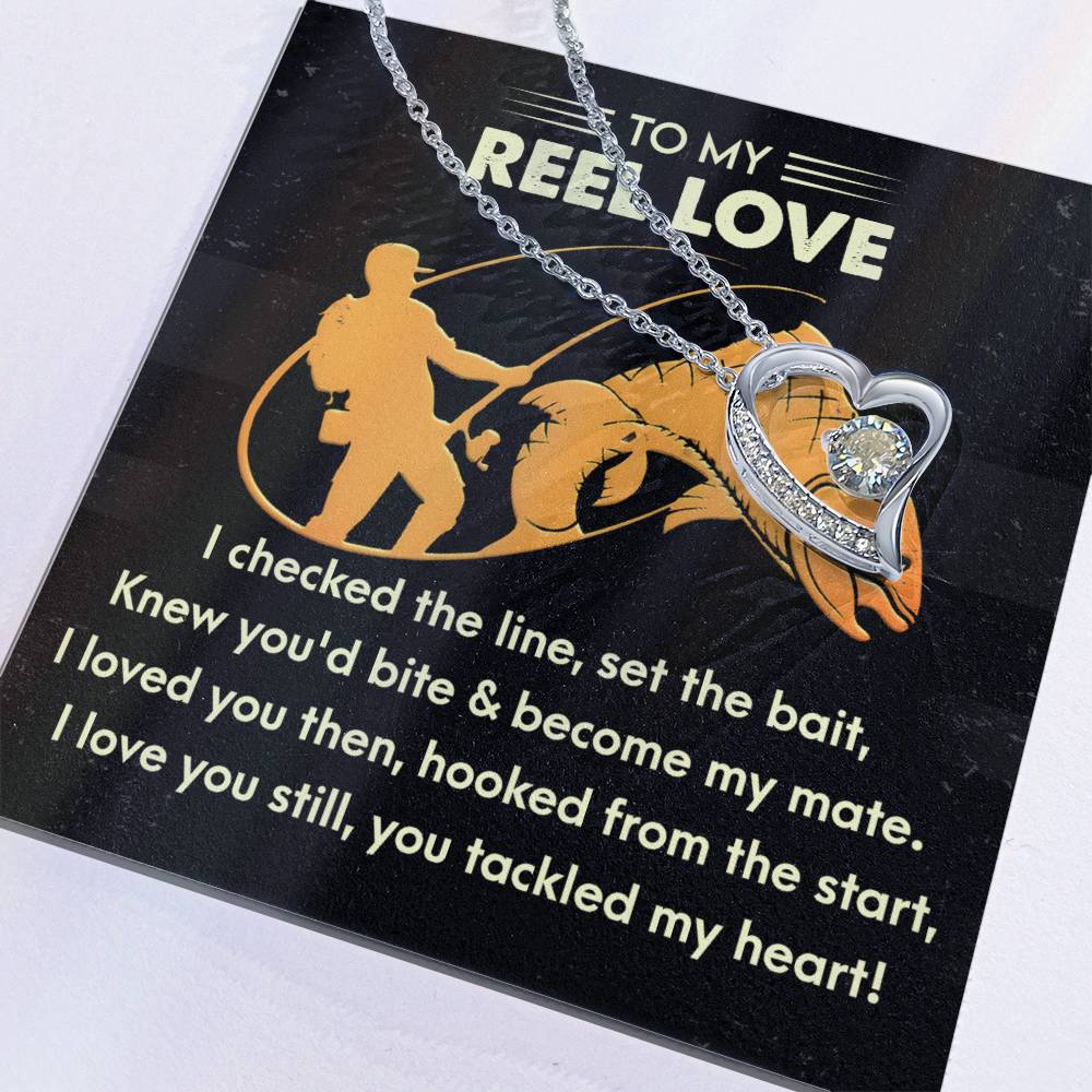 The Soulmate-Tackled My Heart - Forever Love Necklace is heart-shaped, adorned with a CZ crystal, and comes on a card with a fishing-themed design and poem.