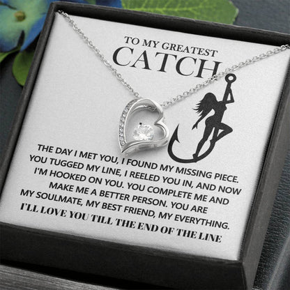 The Soulmate-Hooked On You - Forever Love Necklace boasts a heart-shaped pendant with a cubic zirconia stone, elegantly suspended from a white gold finish chain. It comes on a card displaying a woman on an anchor silhouette, complete with a romantic message.