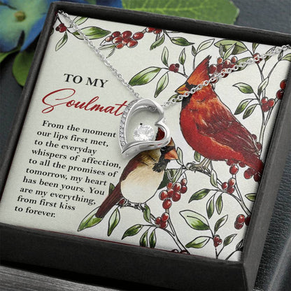 The Soulmate-First Kiss - Forever Love Necklace is embellished with a shimmering CZ crystal and is thoughtfully placed on a card featuring red birds, along with a heartfelt love message, all elegantly packaged inside a gift box.