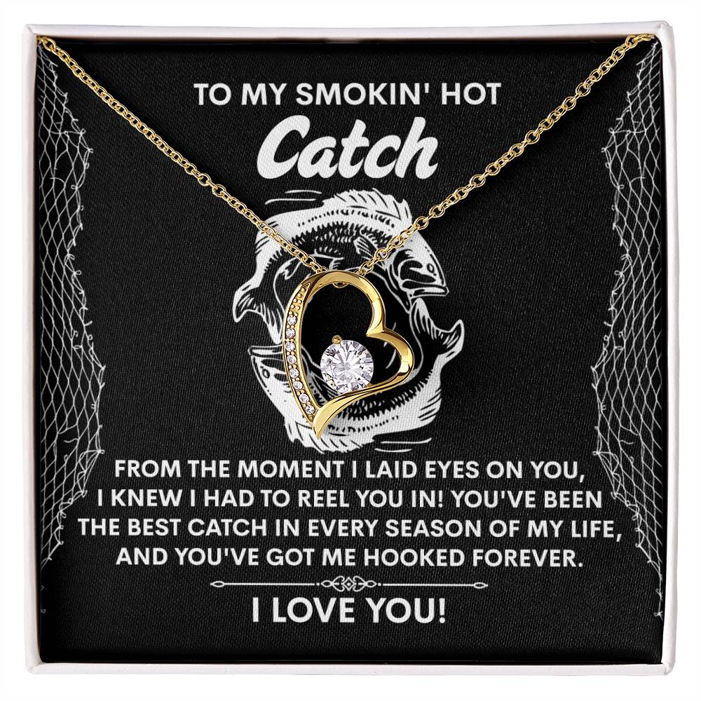 Introducing the Soulmate-Got Me Hooked - Forever Love Necklace, a heart-shaped pendant in gold adorned with a shimmering CZ crystal on a black background. This piece embodies love with its fishing-themed message and is available in an exquisite white gold finish.