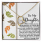 The Daughter-Biggest Fan - Forever Love Necklace showcases a gold heart pendant with a cubic zirconia crystal on a delicate gold-finished chain, beautifully displayed on a message card featuring autumn leaf designs and an affectionate note to your daughter.