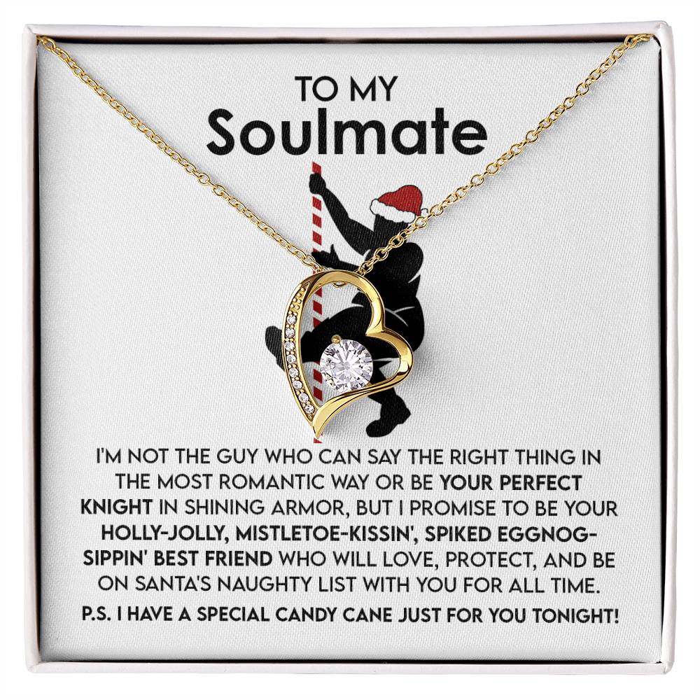 The Soulmate-For All Time - Forever Love Necklace is crafted in 14k white gold, featuring a gold heart-shaped pendant with a sparkling cubic zirconia stone at its center, elegantly presented in an open box. The background highlights a silhouetted couple embracing against a printed romantic message.