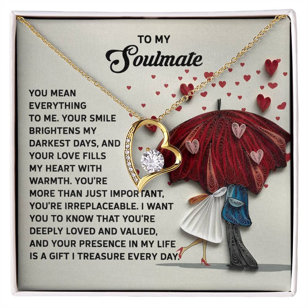 The Soulmate-Deeply Loved - Forever Love Necklace features a heart-shaped pendant with a dazzling CZ crystal and white gold finish. It comes on a heartfelt card illustrating a couple under an umbrella with hearts, making it the perfect expression of love.