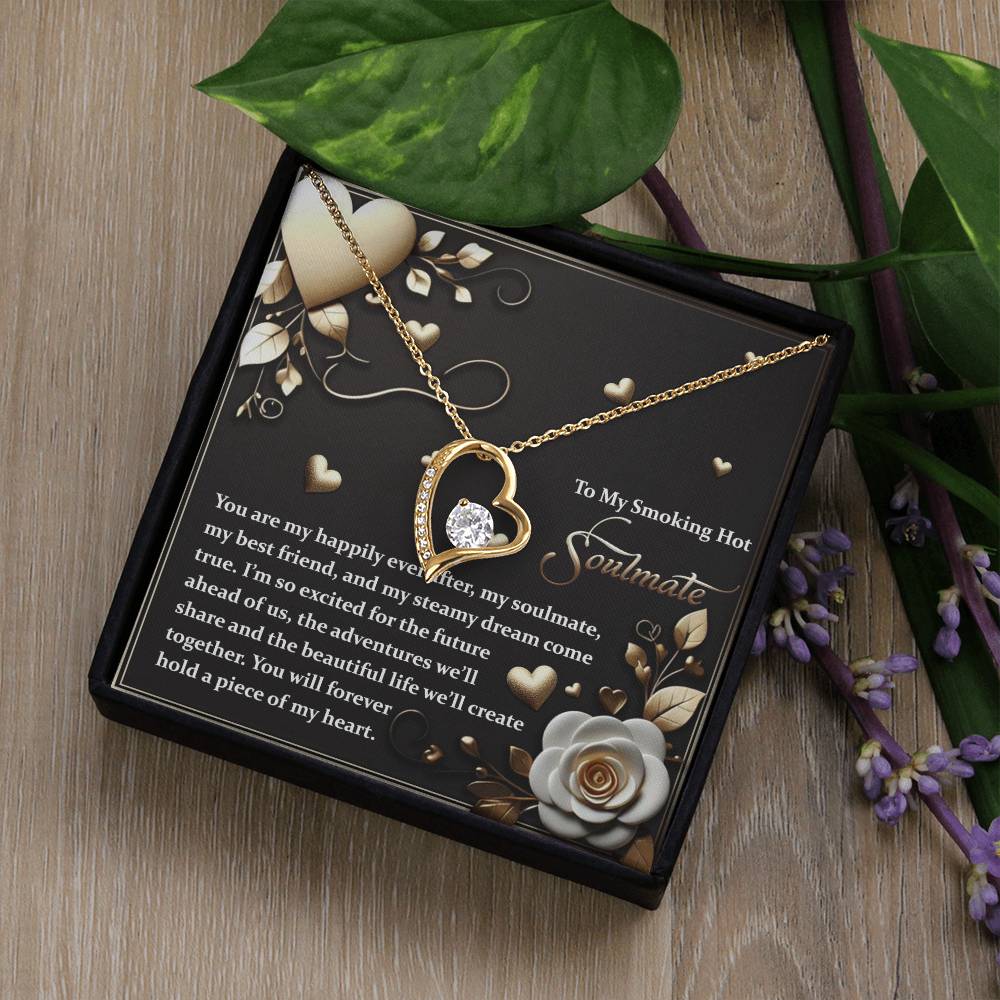 The Soulmate-The Future - Forever Love Necklace showcases a heart-shaped pendant with a radiant cubic zirconia at its center. Its gold finish adds elegance, and it is presented in a box decorated with flowers and a heartfelt message.