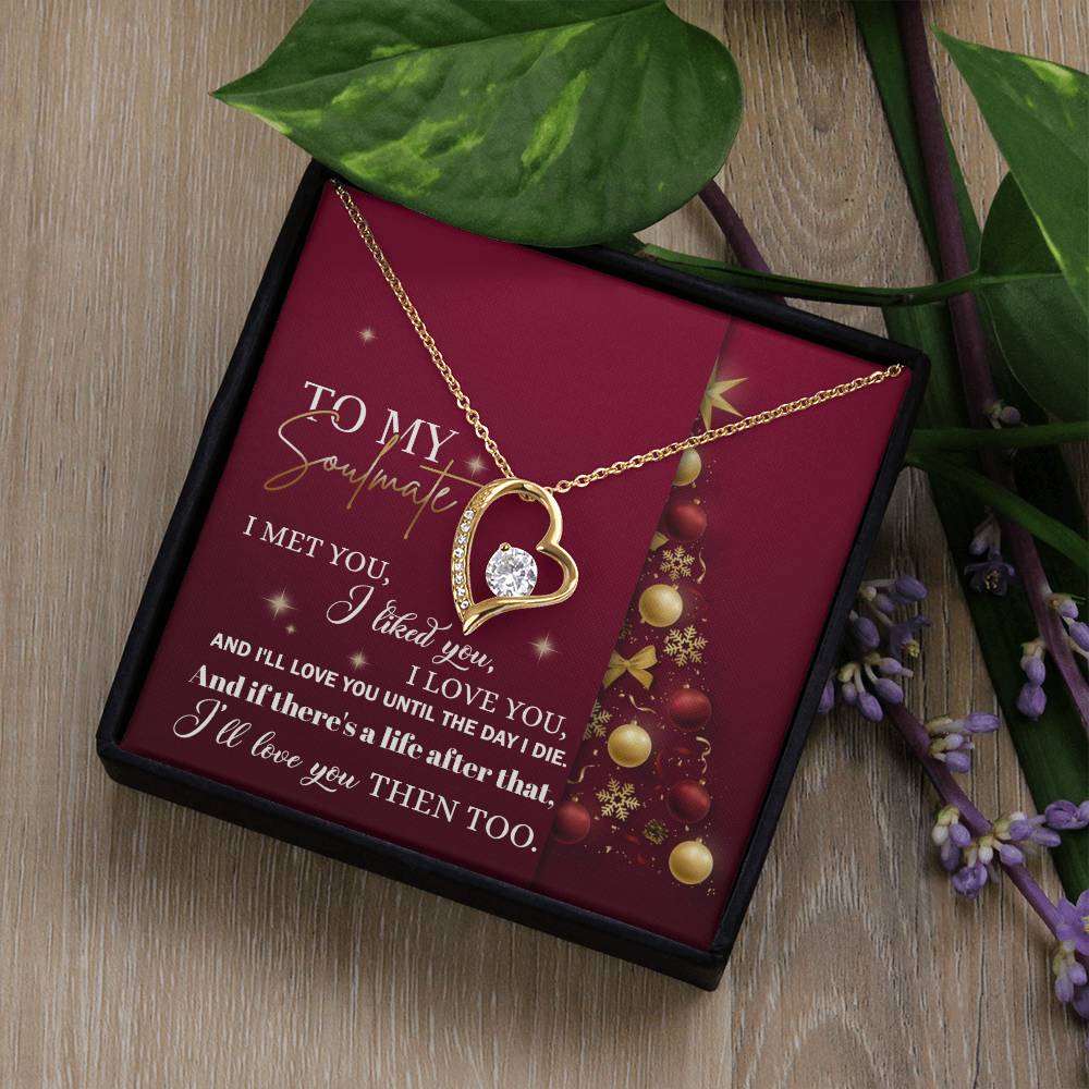 The Soulmate-Love You Then - Forever Love Necklace showcases a heart-shaped design with a central cubic zirconia stone. It is elegantly displayed on a red card with a holiday message to your soulmate, surrounded by green leaves and lavender sprigs.