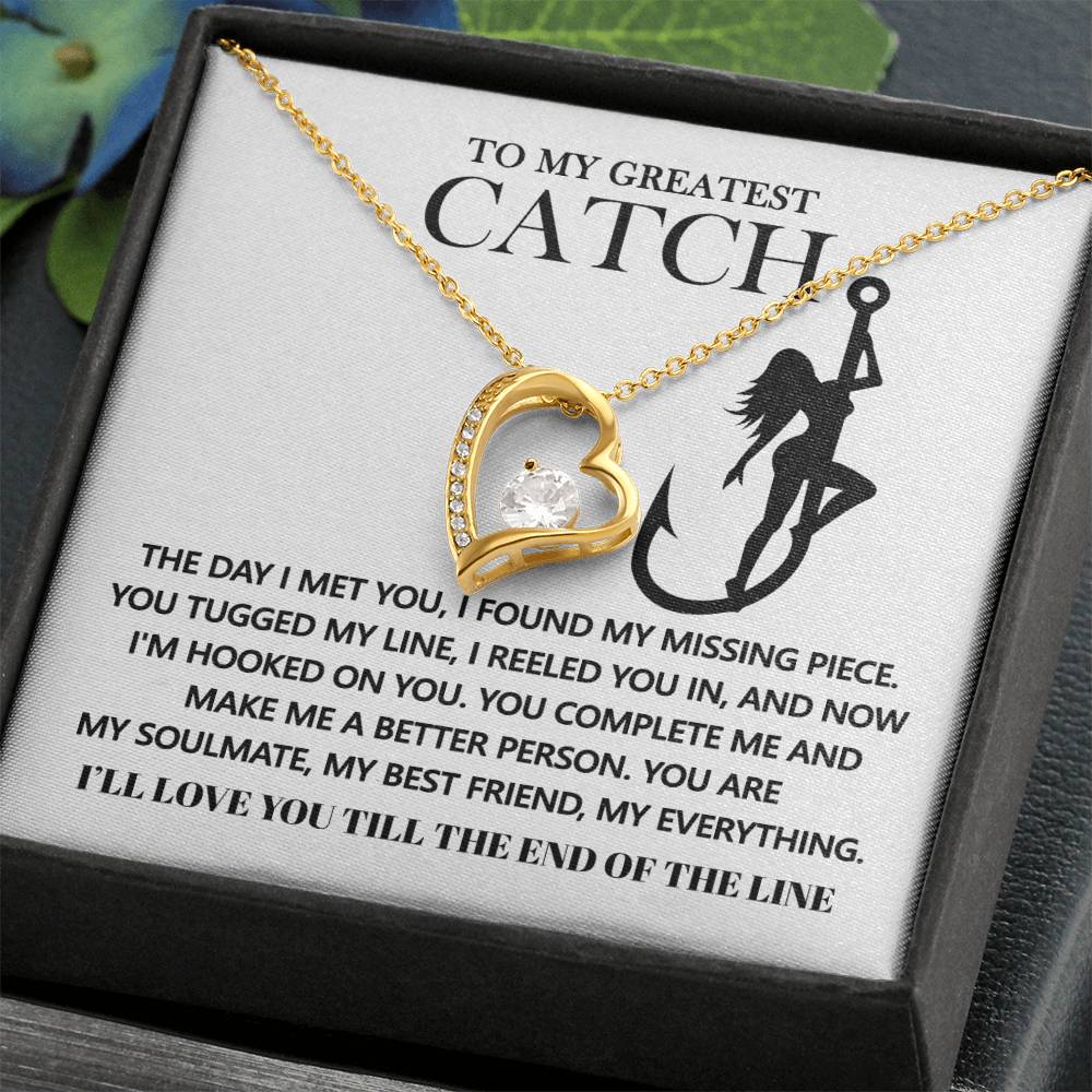 The Soulmate-Hooked On You - Forever Love Necklace showcases a gold heart pendant with a cubic zirconia, elegantly displayed on a card featuring a woman fishing silhouette and a romantic message.