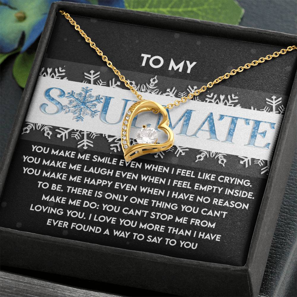 A gold heart necklace with a brilliant cubic zirconia is beautifully displayed on a box adorned with the word "Soulmate" and an affectionate message etched inside, capturing the essence of the Soulmate-Loving You - Forever Love Necklace.