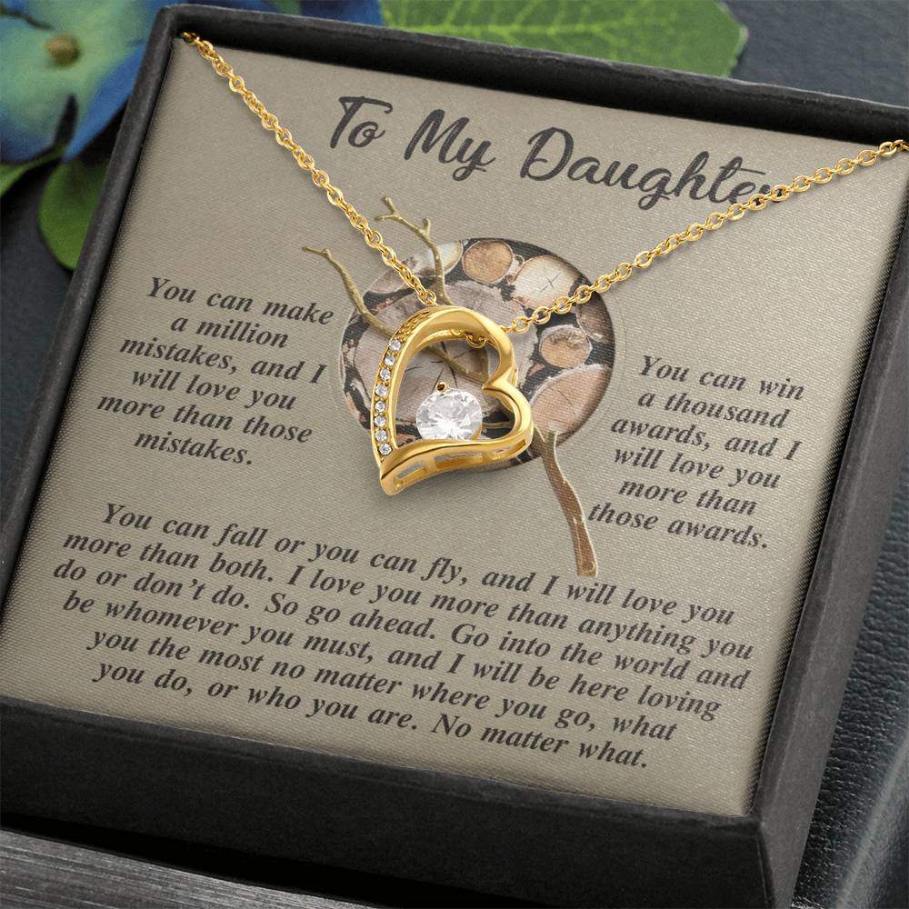 The Daughter-A Thousand Awards - Forever Love Necklace, featuring a stunning gold finish and CZ crystal, is elegantly presented on a sentimental message card titled "To My Daughter," nestled in a beautiful gift box.