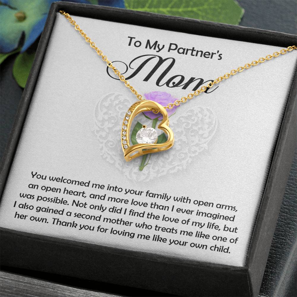 The Partner’s Mom-A Second Mother - Forever Love Necklace, gold-finished with a heart-shaped pendant and central gem, is presented in a gift box featuring a heartfelt thank-you message for your partner’s mom.