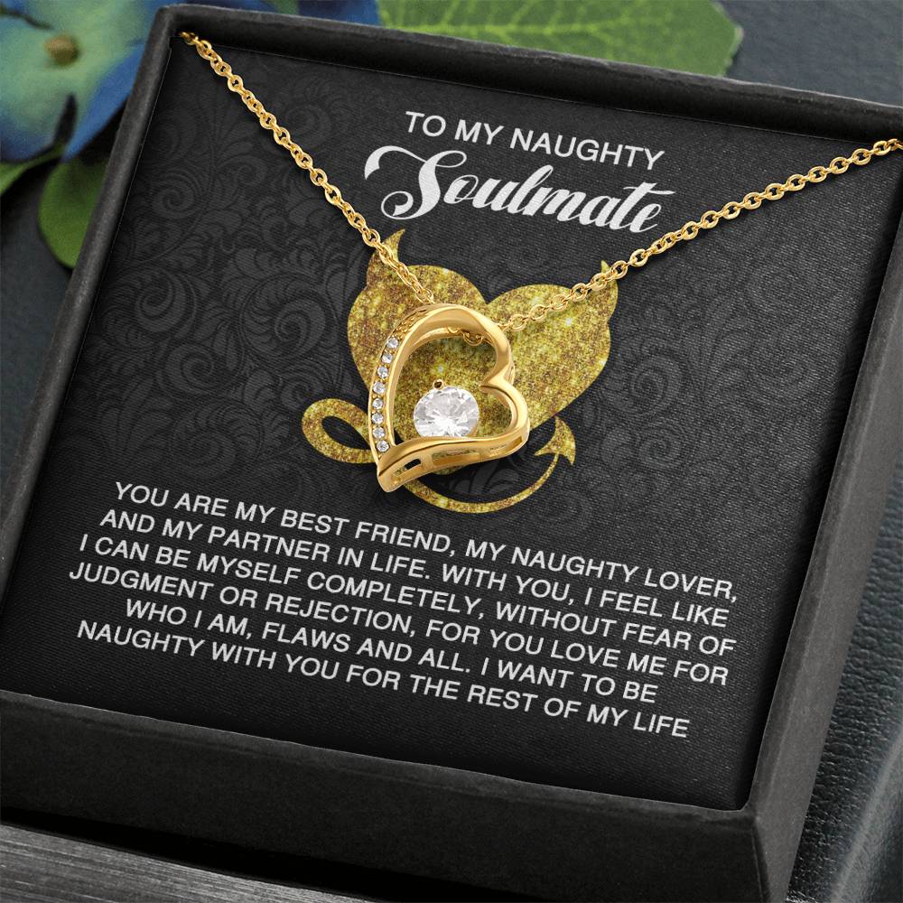 The Soulmate-Naughty With You - Forever Love Necklace showcases a gold heart-shaped pendant and a sparkling cubic zirconia, elegantly displayed over a card with the message "To My Naughty Soulmate" and shares a romantic sentiment.