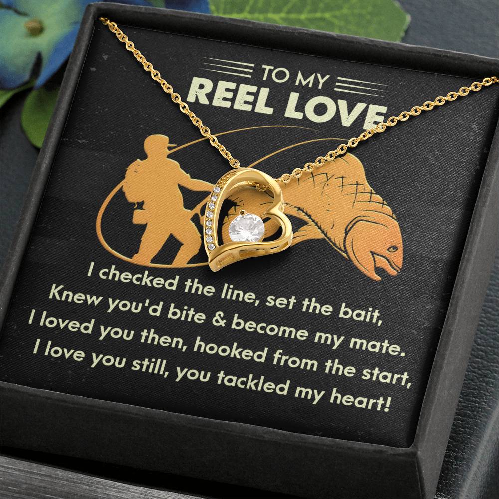 The Soulmate-Tackled My Heart - Forever Love Necklace showcases a gold heart-shaped pendant with a sparkling CZ crystal, complemented by a card bearing a fishing-themed romantic message.