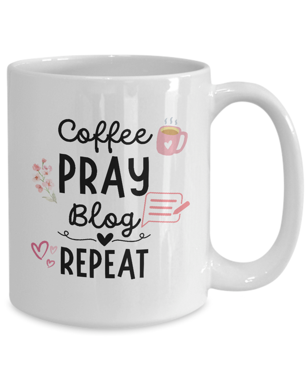 Coffee Pray Blog Repeat" white mug featuring a coffee cup, hearts, and flowers. It's printed and shipped from the USA for a limited time. Perfect gift or appreciation cup for bloggers!.