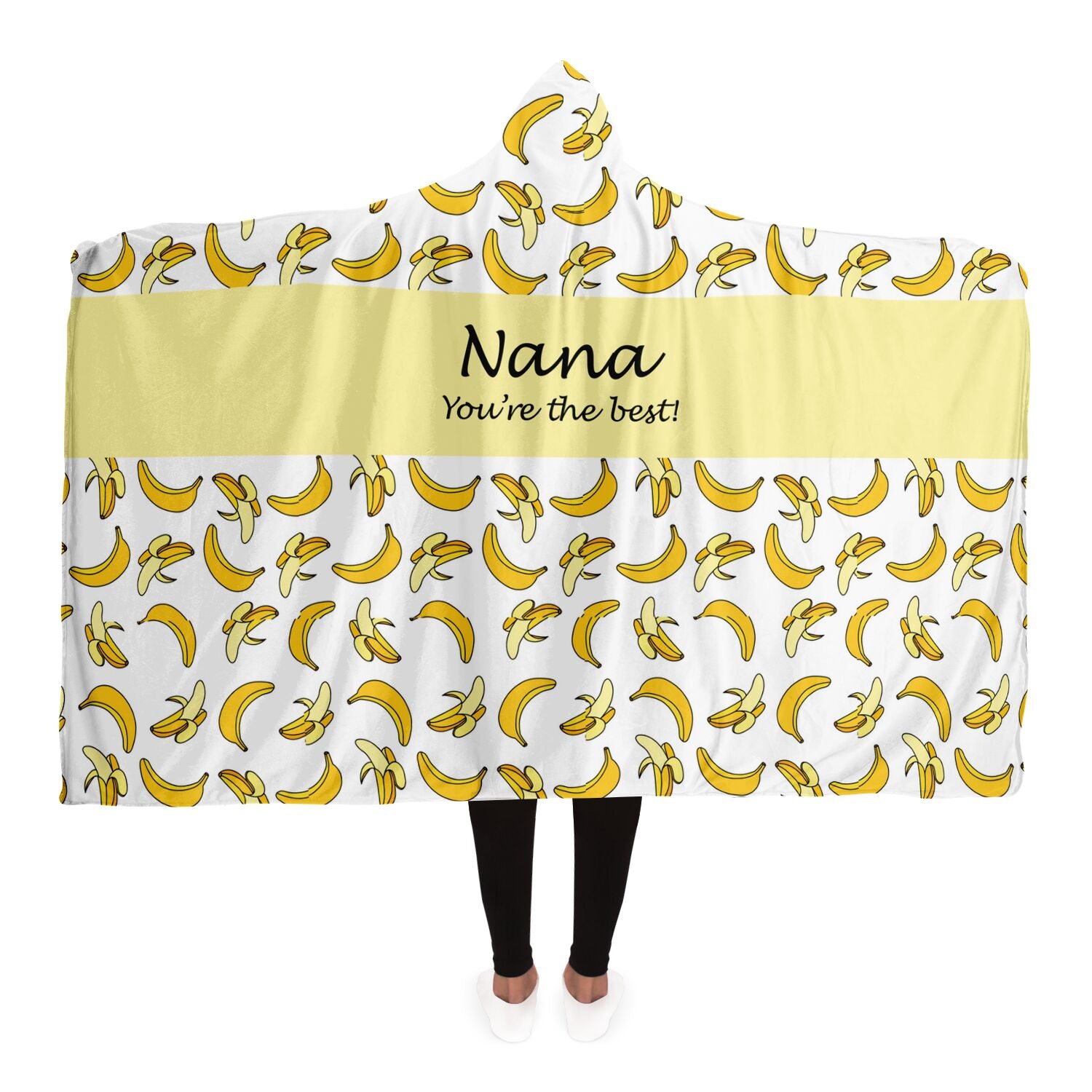 A woman snuggled in a Nana You're The Best Blanket Hoodie with Banana Pattern by Subliminator, with the word nana embroidered on it.